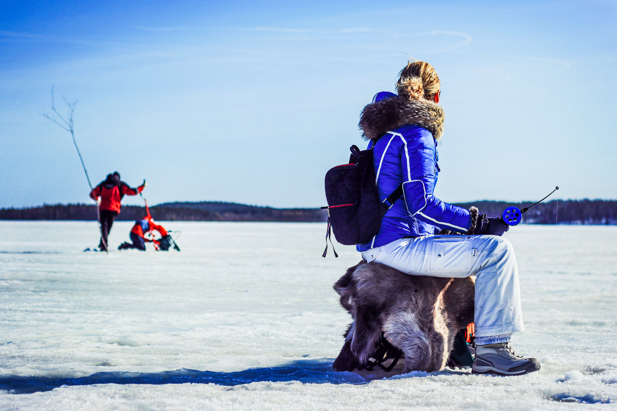 ice fishing on frozen lake