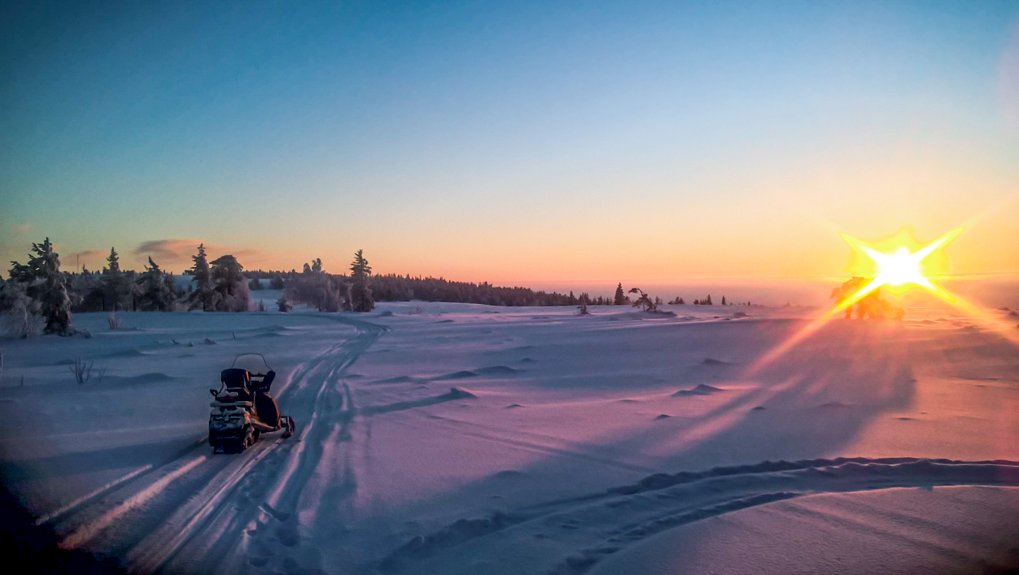 snowmobile with landscape and sunset