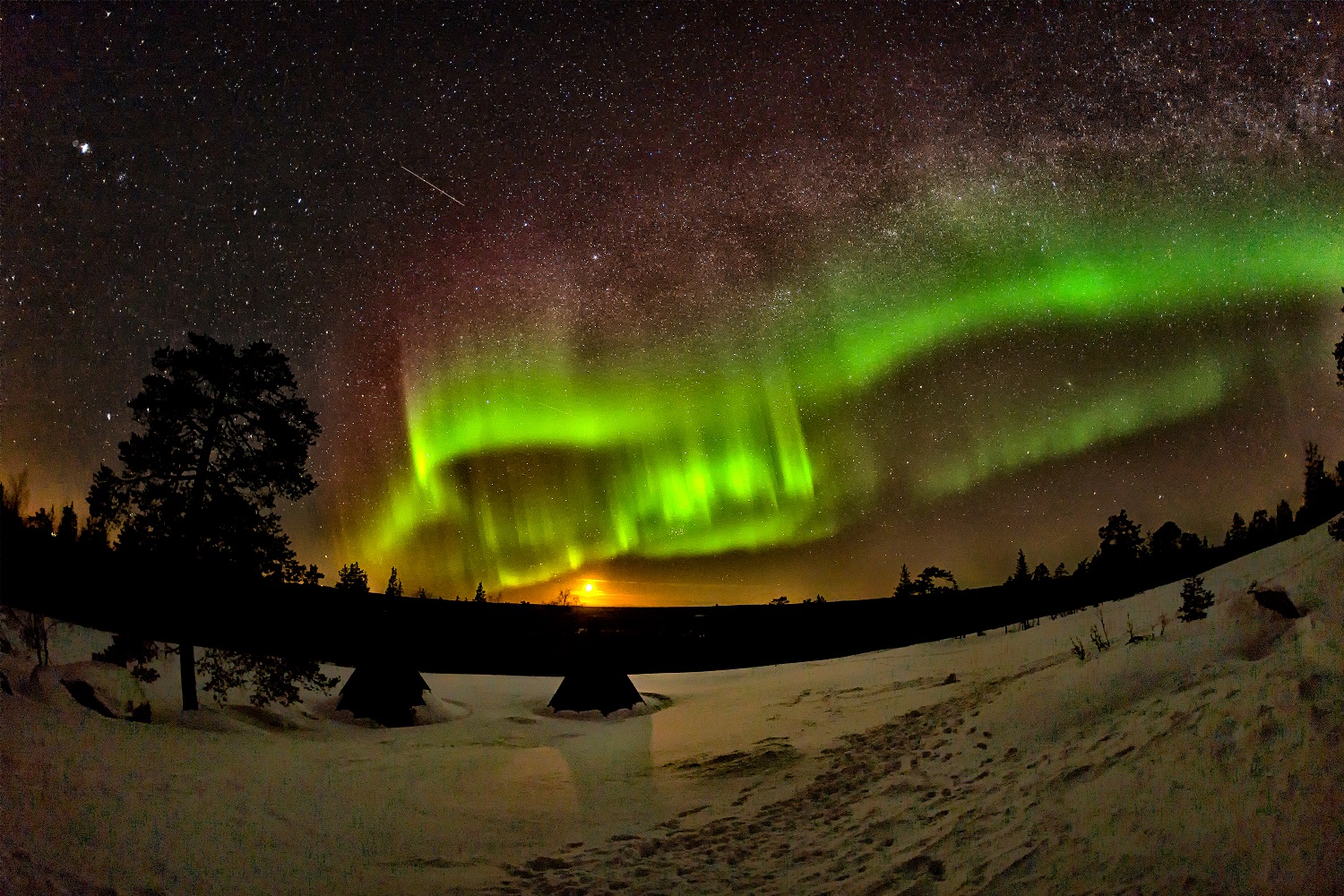 dark sky with bright stars and green northern lights 