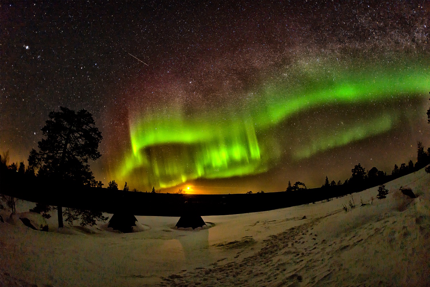 dark sky with bright stars and green northern lights