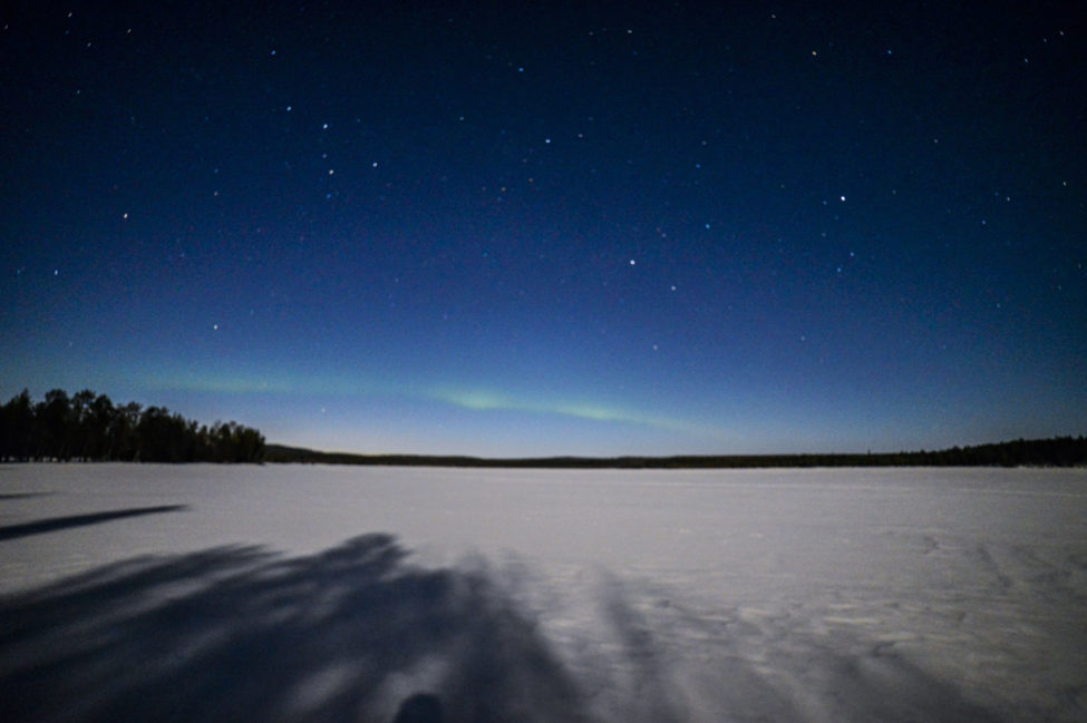 A pale northern lights arc in a bright moonlit sky 05.04.2020 - Lapland ...